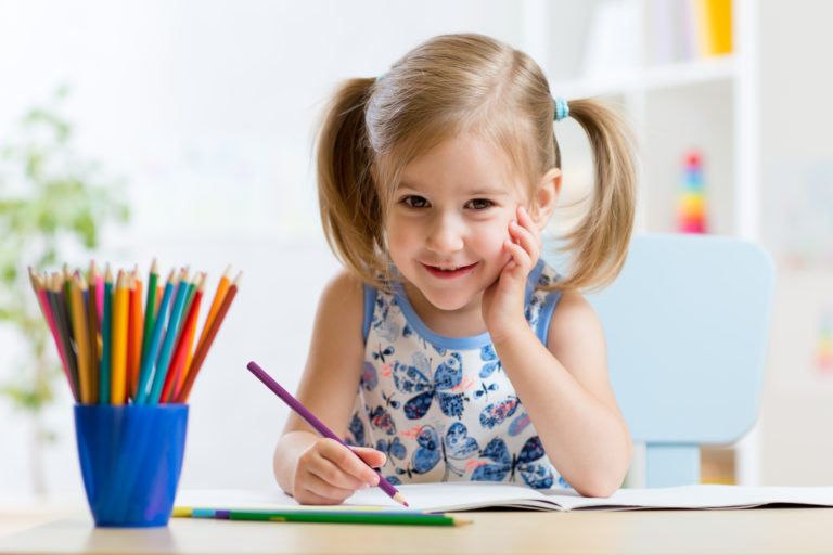 Cute little girl child kid drawing at home